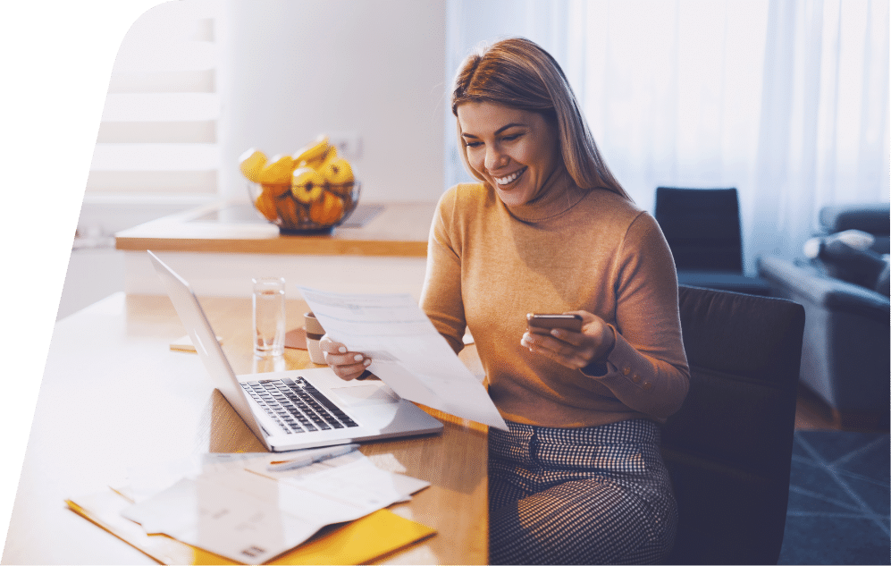 a person sitting at a table using a laptop