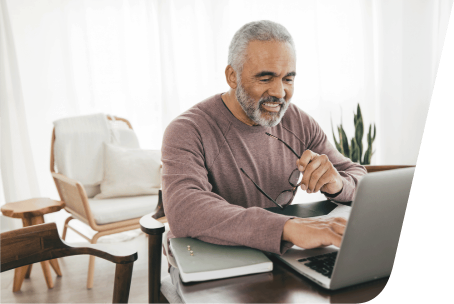 a man sitting at a table using a laptop