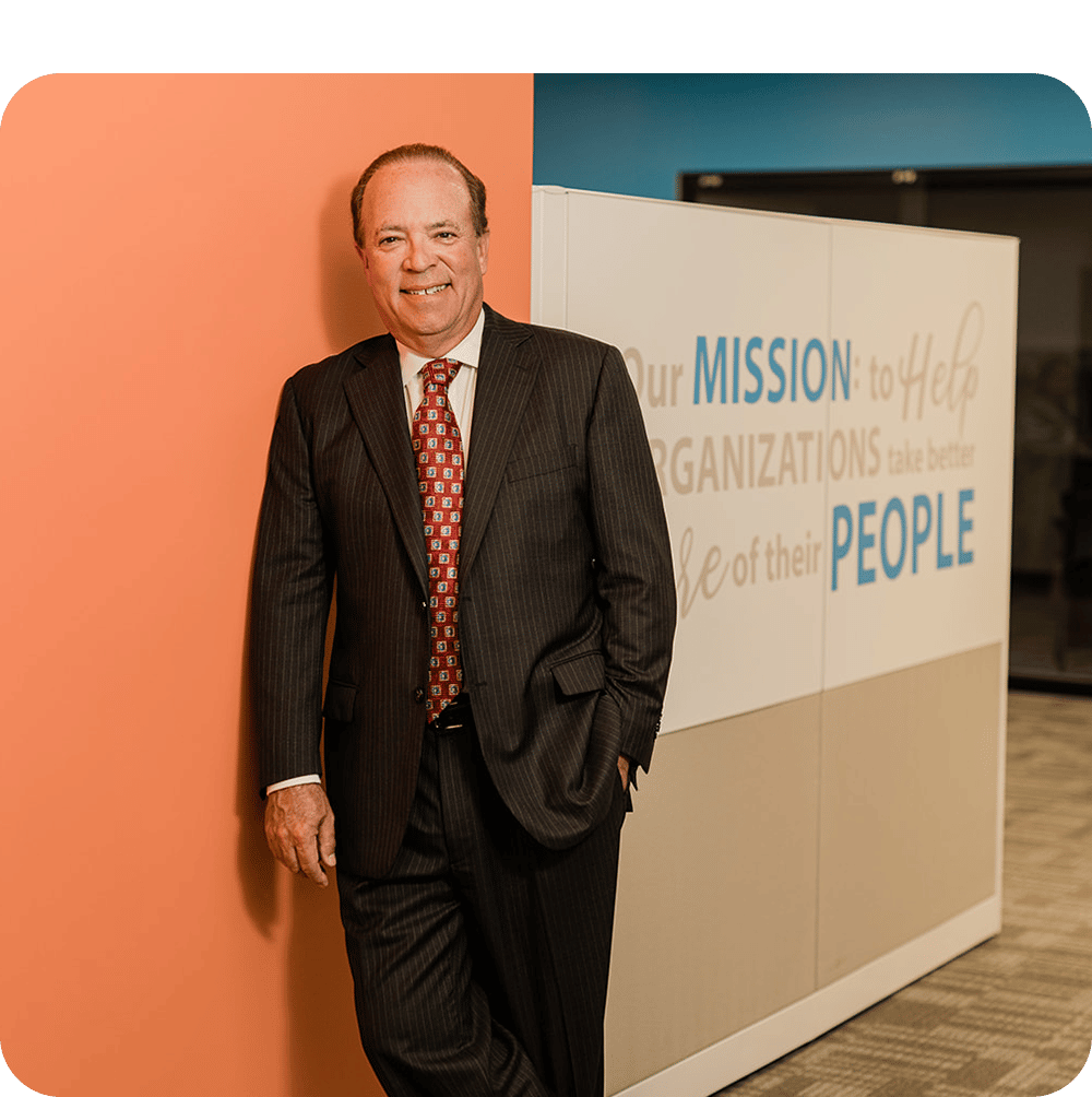 a man wearing a suit and tie in a corporate office