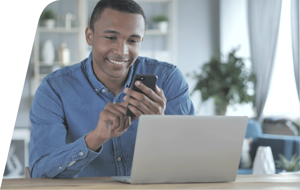 a person sitting in front of a laptop