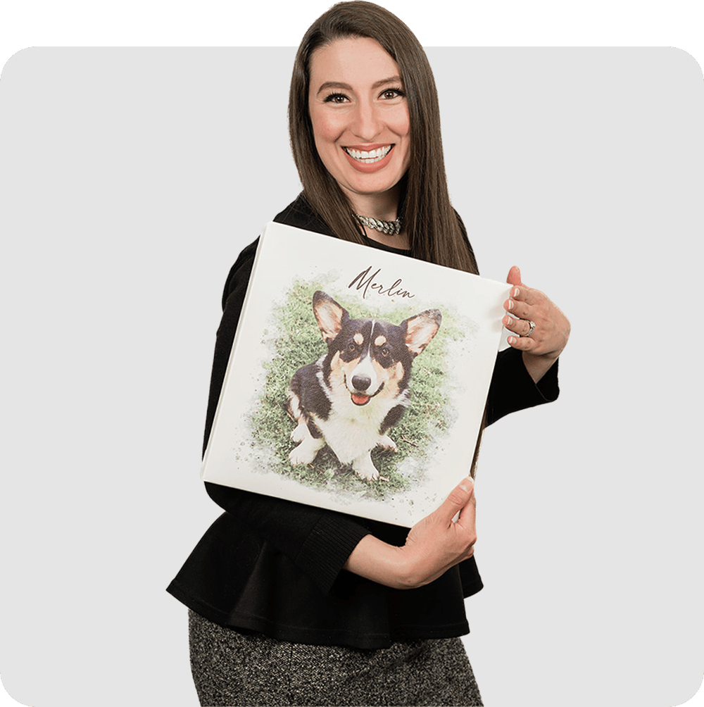 A young professional woman holding a picture of her dog