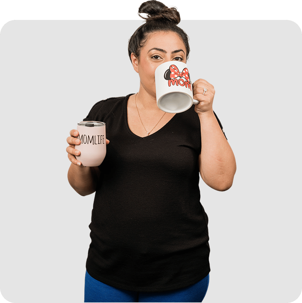 A woman drinking from two cups of coffee