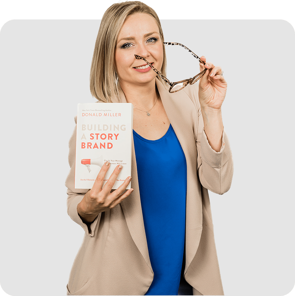 A woman holding Donald Miller's book "Building a Story Brand"