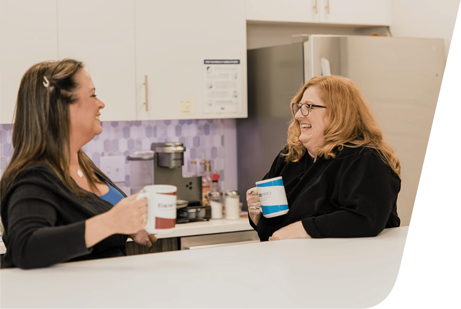 Two coworkers sitting in the breakroom