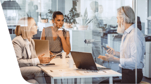 a group of people looking at a laptop